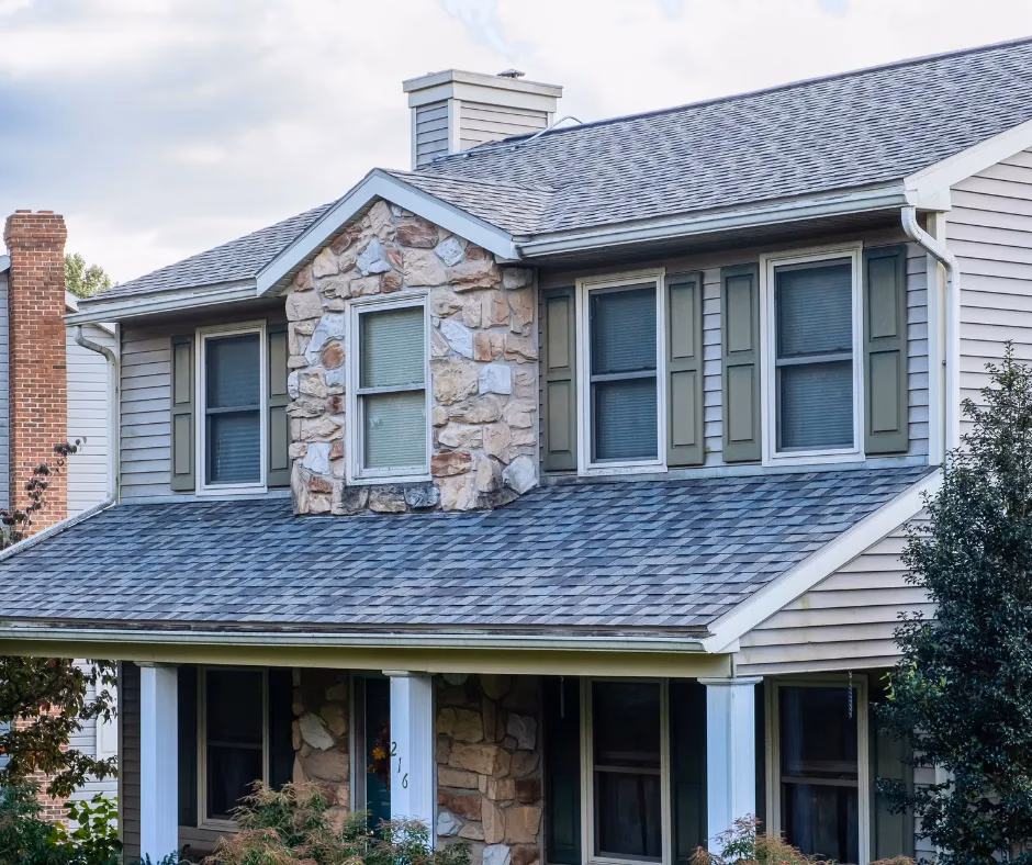 House exterior featuring a combination of stone and siding, with green shutters and a well-maintained roof, emphasizing residential architecture for potential marketing services.